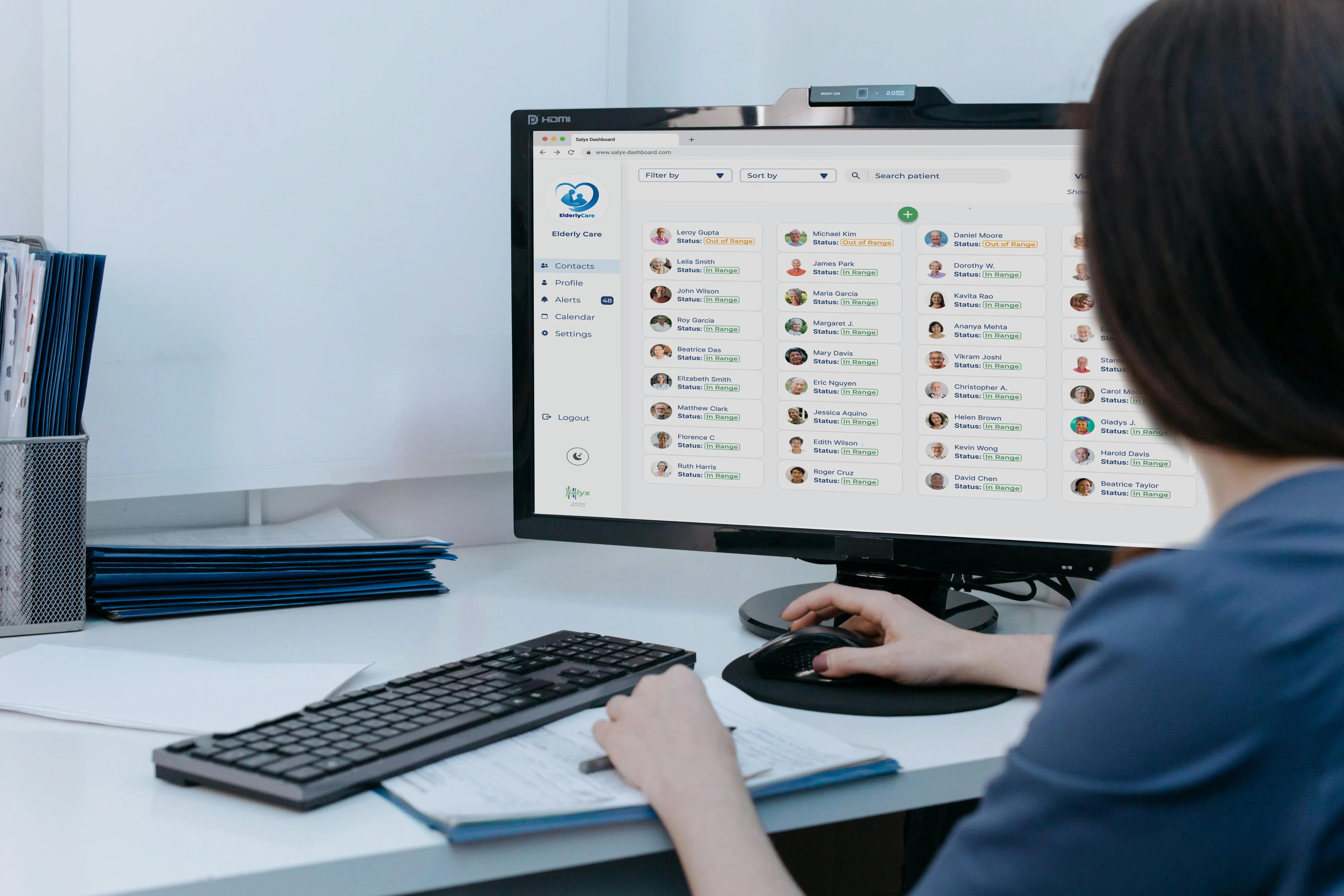 A staff member from a retirement home navigating through the Salyx dashboard on their desk.